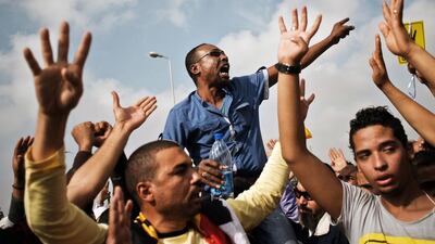 Brotherhood supporters protest in Cairo at the start of Mohammed Morsi’s trial on charges of incitement to violence. Gian Luigi Guercia / AFP
