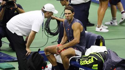 Rafael Nadal received treatment on court before he retired from his semi-final with Juan Martin del Potro at the US Open. EPA