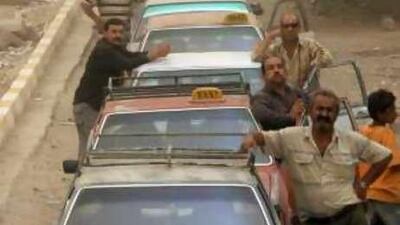 Motorists queue for gasoline at a petrol station in Baghdad. When Nizar Lane tried to interview motorists, he was beaten by Iraqi soldiers.
