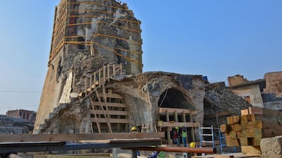 Iraqi workers build scaffolding during the reconstruction of "Al-Hadba" leaning minaret in Mosul. AFP