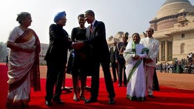 US President Barack Obama shakes hands with Indian Prime Minister Manmohan Singh as his wife Gulcharan Kau (L), First Lady Michele Obama (3R) and President Pratiba Patil (R) look on during a welcoming ceremony at the Presidential palace in New Dehli on November 8, 2010. Obama hailed India as an established "world power" as he received a 21-gun salute at a red carpet state welcome in the capital New Delhi. AFP PHOTO/Pedro UGARTE