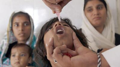 A girl receives polio vaccine drops at a government dispensary in Karachi. (Akhtar Soomro / Reuters)