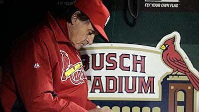 Tony La Russa makes notes in Game 6 of the World Series, as his numerous decisions throughout the post-season crafted St Louis to their 11th World Series.