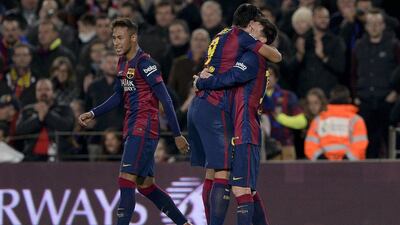 Barcelona's Luis Suarez, right, celebrates with Lionel Messi with Neymar, left, nearby after Suarez's goal for Barcelona during their 3-1 win over Atletico Madrid in La Liga on Sunday night. Josep Lago / AFP / January 11, 2015