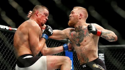 Conor McGregor, right, lost for the first time in the UFC against Nate Diaz, left, and their rematch has been cancelled. Eric Jamison / AP Photo