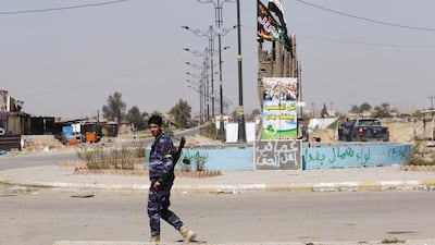 A Sunni fighter who has joined Shiite militia groups known collectively as Hashid Shaabi (Popular Mobilization), allied with Iraqi forces against the ISIL, walks along a street in Al Alam Salahuddin province on March 15, 2015. Thaier Al-Sudani/Reuters