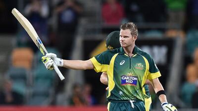 Australia's Steven Smith raises his bat after scoring a century during his side's ODI win over England with a ball remaining on Friday. Theo Karanikos / AFP / January 23, 2015