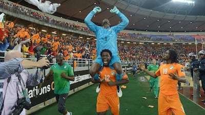 Ivory Coast's Wilfried Bony carries goalkeeper Boubacar Barry on his shoulders as they celebrate with forward Gervinho after winning the 2015 Africa Cup of Nations final against Ghana. Carl de Souza / AFP