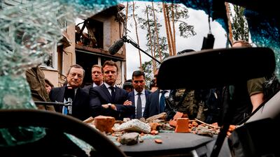 Italian Prime Minister Mario Draghi, left, and French President Emmanuel Macron visit Irpin, outside Kyiv, and survey damage following Russia's invasion. AP