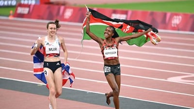 Winner Kenya's Faith Kipyegon and second-placed Britain's Laura Muir celebrate with their flag after the women's 1500m final.