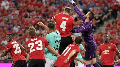 Manchester United's goalkeeper David de Gea punches the ball clear. AFP