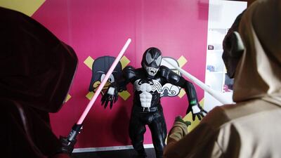 A man dressed as Venom faces off with two Jedis at the Middle East Film and Comic Con in Dubai. Sarah Dea / The National