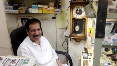 Maqsood Ahmed, a clock and watch repairman, sits in his shop in Abu Dhabi’s Al Zahiyah neighbourhood. John Dennehy / The National