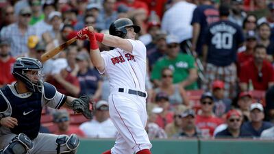 Boston Red Sox's Andrew Benintendi, right, takes his at bat as New York Yankees' Gary Sanchez, left, looks on in the eighth inning of their MLB clash in August. The Red Sox are now under investigation, subsequently, for allegedly sign-stealing, using a watch, during the series with the Yankees. Steve Senne / AP Photo