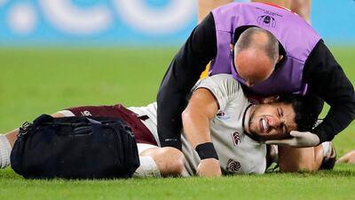 Georgia's Gela Aprasidze receives medical attention. AP