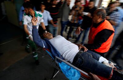 A Palestinian, who was wounded at the Israel-Gaza border, is carried into a hospital in Gaza City. Mohammed Salem/ Reuters