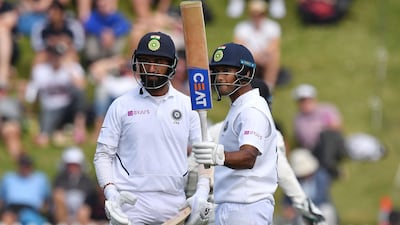 India's Mayank Agarwal, right, celebrates after reaching fifty at the Basin Reserve in Wellington. AFP