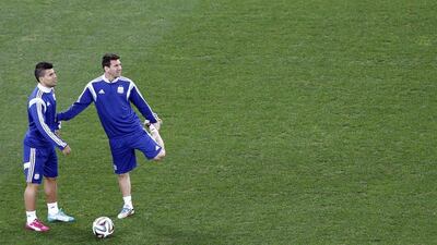 Sergio Aguero and Lionel Messi of Argentina stretch during a team training session ahead of Sunday's 2014 World Cup final in Rio de Janeiro, Brazil. Tolga Bazoglu / EPA / July 9, 2014