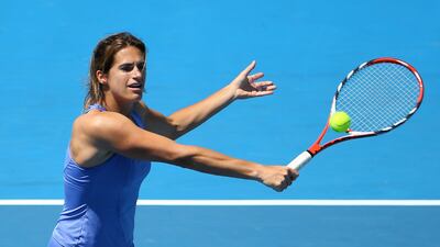 Amelie Mauresmo of France plays a backhand in her second-round legends doubles match with Lindsay Davenport of the United States against Iva Majoli of Croatia and Barbara Schett of Austria during the Australian Open on January 23, 2013 in Melbourne, Australia. Lucas Dawson / Getty Images