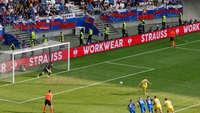 Romania's Razvan Marin scores from the penalty spot to make it 1-1 in Frankfurt. Reuters