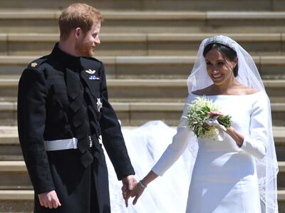 Britain's Prince Harry, left, Duke of Sussex and Meghan, Duchess of Sussex exit St George's Chapel in Windsor Castle after their royal wedding ceremony. EPA