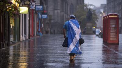 A lone "yes" campaign supporter walks down a street in Edinburgh after the result of the Scottish independence referendum, Scotland, on Friday. Stefan Rousseau / AP Photo