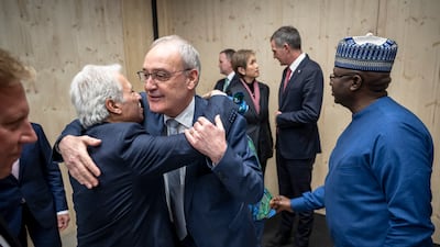 Swiss President Guy Parmelin, centre, welcomes Saudi Minister of Commerce Majid Al Qassabi, centre left, at the opening of the World Trade Organisation's informal ministerial gathering in Davos. EPA