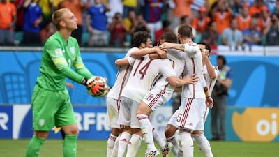 Spain players celebrate after Xabi Alonso's first-half penalty goal to go up 1-0 on Friday against Netherlands at the 2014 World Cup in Salvador, Brazil. Javier Soriano / AFP