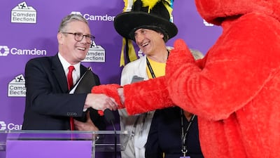 Keir Starmer shakes hands with defeated candidates Nick the Incredible Flying Brick and Bobby "Elmo" Smith at Camden Council headquarters after retaining his Holborn and St Pancras seat in the July 2024 general election. PA