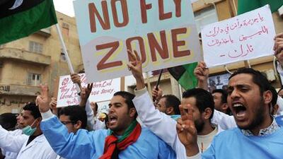 Doctors working at a local hospital join other protesters in calling for a no fly zone over Libya during a rally in Benghazi today.