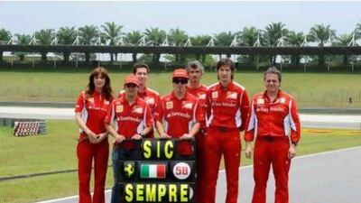 Members of the Ferrari team pay tribute to Marco Simoncelli, the Italian MotoGP rider, who was killed in a crash in Malaysia.