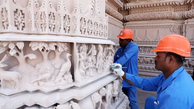 Workers making the final touches to the carvings. Pawan Singh / The National