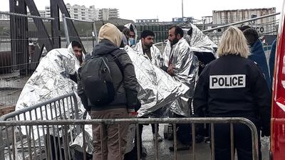 French rescue teams help a group of 17 migrants in Calais, after they were rescued off the northern France. AFP