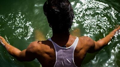 Salim, a local Nizamuddin resident, enjoys the water at the Hazrat Nizamuddin Baoli.