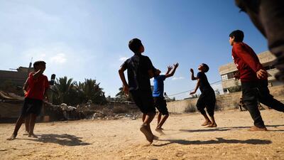 Palestinians play football in a neighbourhood in Gaza amid soaring temperatures and power cuts. AFP