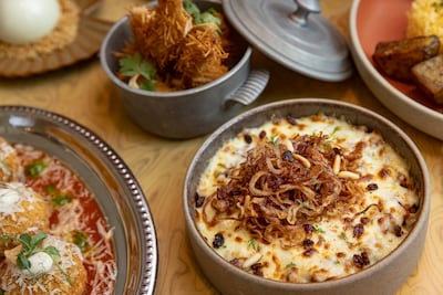 Dishes at Murmur include machboos arancini, saffron lobster rolls and karak-flavoured cheesecake. Antonie Robertson / The National