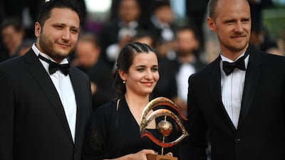 Syrian actor Hamza al-Kateab, Syrian director and producer Waad al-Kateab and British director Edward Watts pose with the Oeil d'Or prize at the 72nd edition of the Cannes Film Festival in Cannes, southern France, on May 25, 2019. AFP
