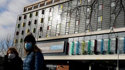 People outside a hotel near Heathrow Airport in London. The UK government has announced that a booking website will be used for its new hotel quarantine system. AP