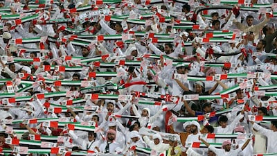 UAE fans hold up scarves during Tuesday night's World Cup qualifying match agains Saudi Arabia at the Mohammed bin Zayed Stadium in Abu Dhabi. Satish Kumar / The National / March 29, 2016