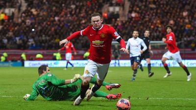 The moment in question as Wayne Rooney tumbles to the turf and is awarded a penalty during Manchester United's FA Cup victory over Preston. Michael Regan / Getty
