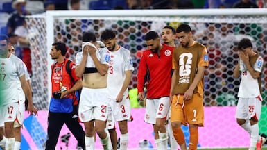 Tunisia players look dejected after the match. Reuters