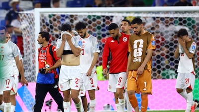 Tunisia players look dejected after the match. Reuters