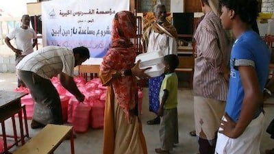 Displaced families from the Abyan region collect donated food from a charity at a school in the southern city of Aden in September last year. Families with infants say they are not given enough food and worry about malnutrition.