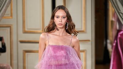 Trousers are layered with a high/low dress at Armani Prive haute couture.