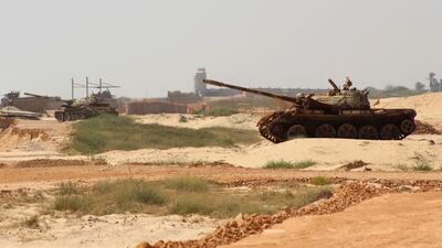 Yemeni pro-government forces tanks are positioned near Mukalla airport. AFP