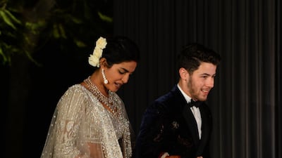Newlyweds Priyanka Chopra, 36, and Nick Jonas, 26, pose for a photograph during a reception at a hotel in New Delhi on December 4, 2018. Photo: AFP