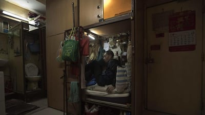 Wong Tat-ming, 63, sits in his ‘coffin home’. It’s crammed with all his meagre possessions, including a sleeping bag, small colour TV and electric fan.
