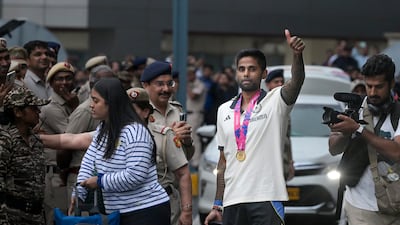 Suryakumar Yadav greets fans as he arrives with the Indian team at the Indira Gandhi International Airport in New Delhi on Thursday, July 4, 2024. AP