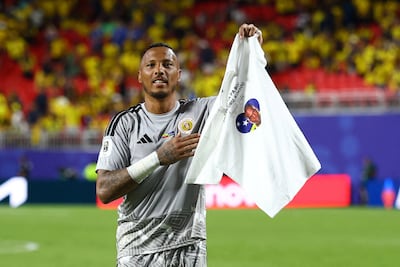 Eloy Room holds up a shirt in memory of Jairzinho Pieter after Curacao's draw with Ecuador in Kansas City. Reuters