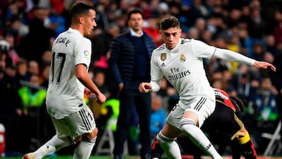 Real Madrid midfielder Federico Valverde, right, dribbles the ball during the match against Rayo Vallecano. AFP